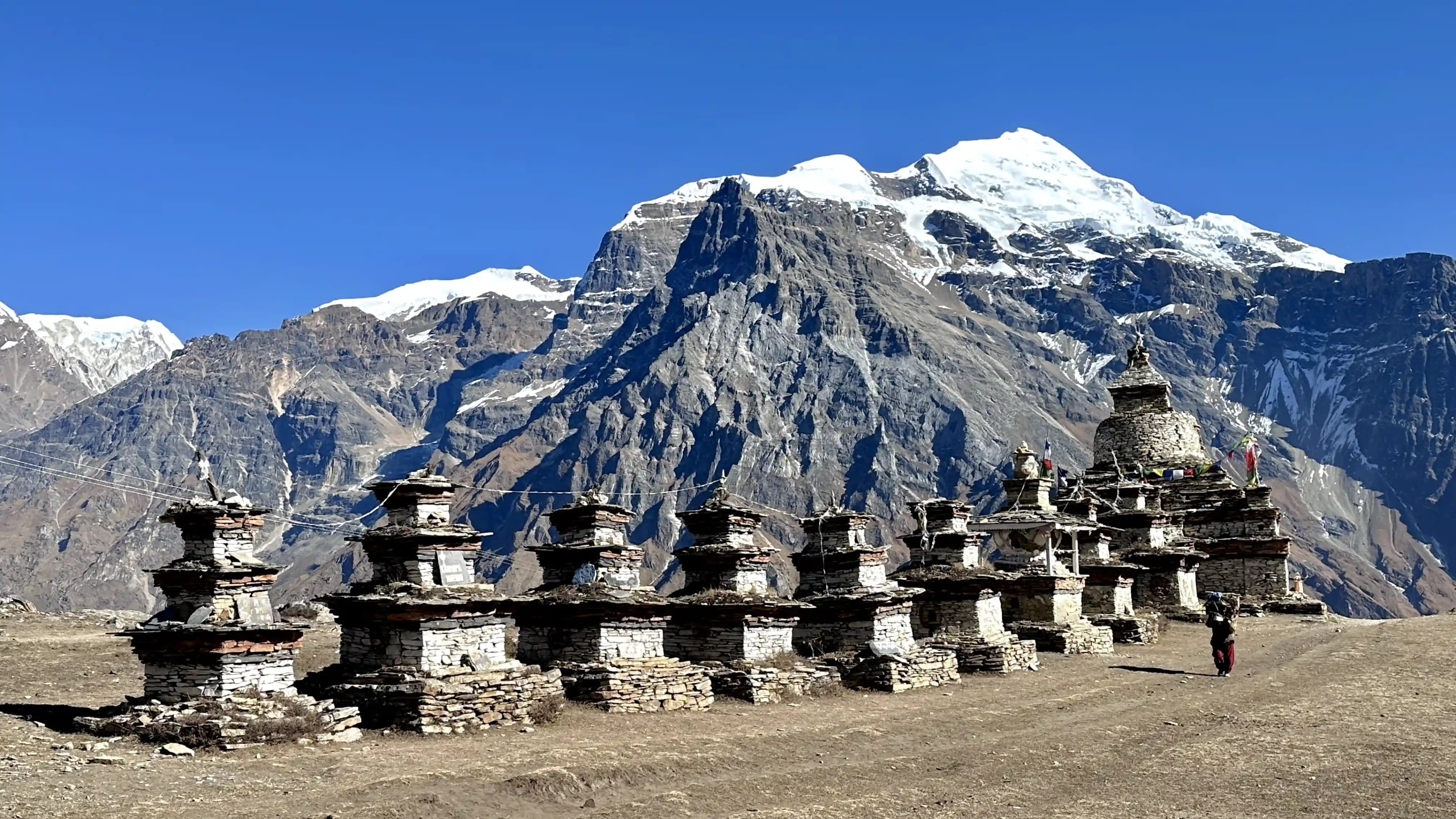 Old chortens (memorials) and the view of mountain peaks during the Nar Phu trek
